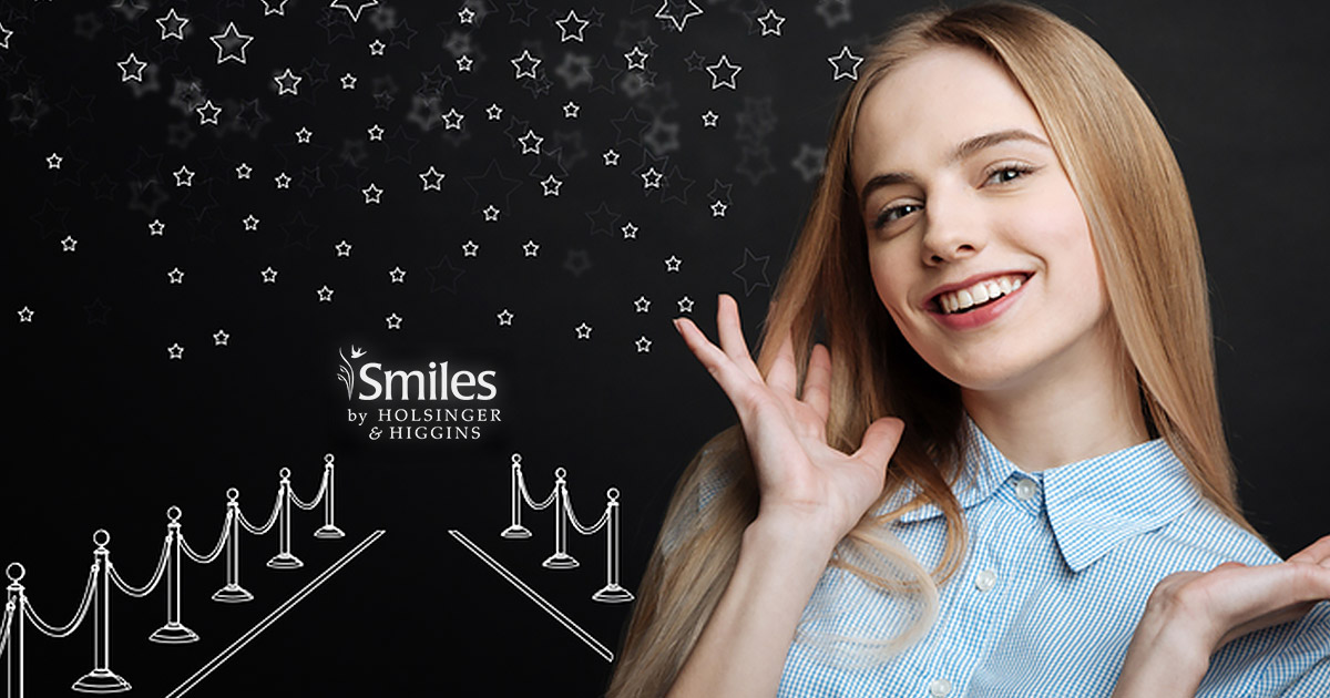 H&H-Blog-November-2018 woman smiling in fron of simulated red carpet drawing